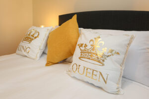 King and Queen cushions in Dunluce Castle bedroom at The Ferns